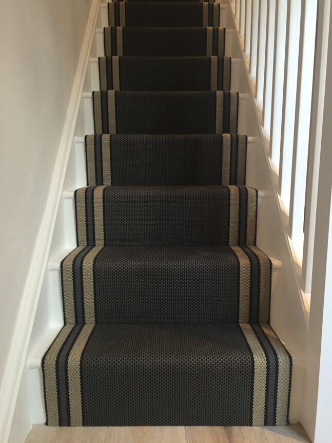 A staircase professionally finished with a runner